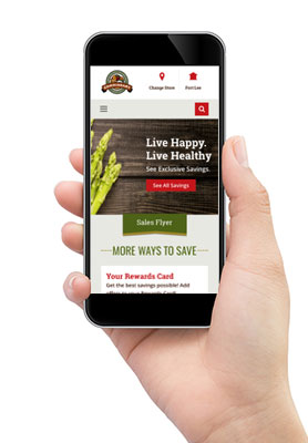 A hand holds a smart phone showing the new commissaries.com homepage