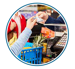 Shopper handing VHIC card to cashier